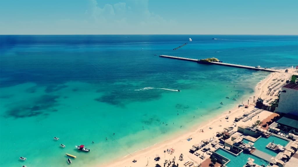 Aerial view of Mamitas Beach club, turquoise Caribbean water, and pier in Playa del Carmen